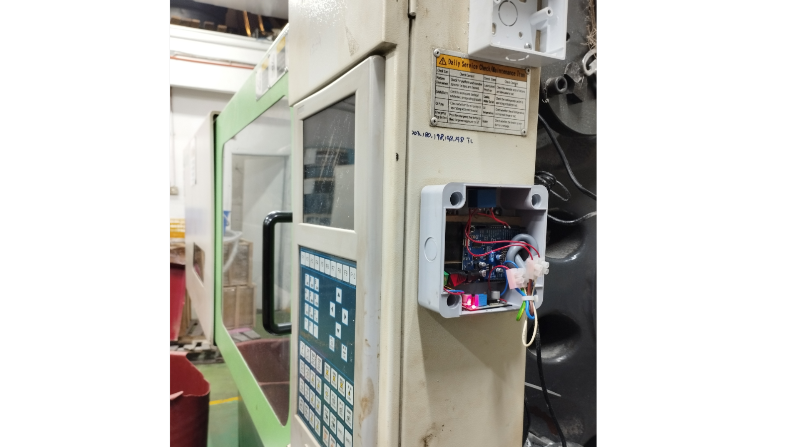 Counter System (IoT) real-time machine monitoring dashboard on a factory TV screen